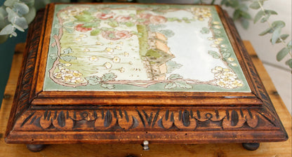 1920s French Antique Ceramic Tile Trivet Hot Plate with Hand-Carved Footed Wooden Base "Trépied Dessous de Plat en Faience" former music box